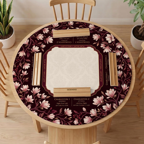 Cream American mahjong mat with a burgundy border of pale pink magnolia blossoms and printed play-direction and passing reminders.