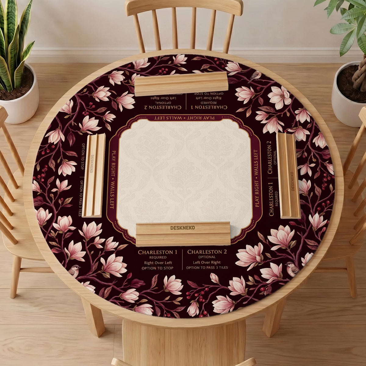 Cream American mahjong mat with a burgundy border of pale pink magnolia blossoms and printed play-direction and passing reminders.