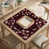 Cream American mahjong mat with a burgundy border of pale pink magnolia blossoms and printed play-direction and passing reminders.