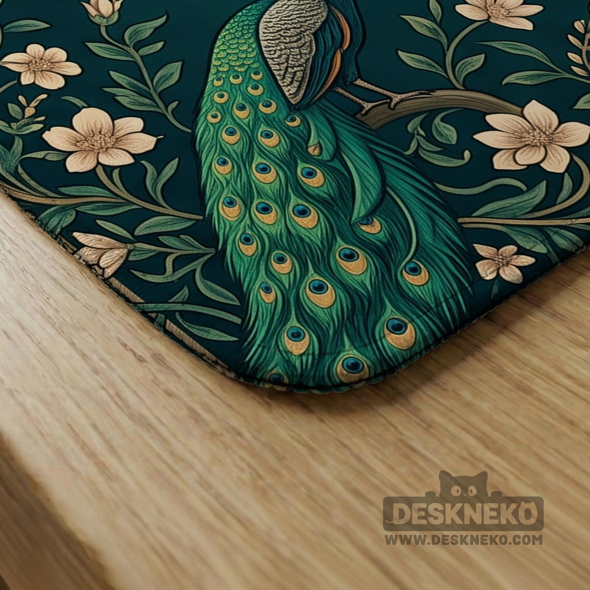 American mahjong mat with a deep teal-green background, peacocks, small cream flowers, leafy branches, and printed play-direction and Charleston reminders.