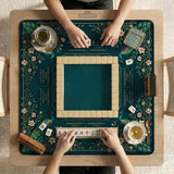 American mahjong mat with a deep teal-green background, peacocks, small cream flowers, leafy branches, and printed play-direction and Charleston reminders.