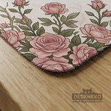 American mahjong mat with an ivory center, printed play-direction reminders, and a border of dusty-pink roses, ribbon bows, and green leaves.