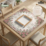 American mahjong mat with an ivory center, printed play-direction reminders, and a border of dusty-pink roses, ribbon bows, and green leaves.