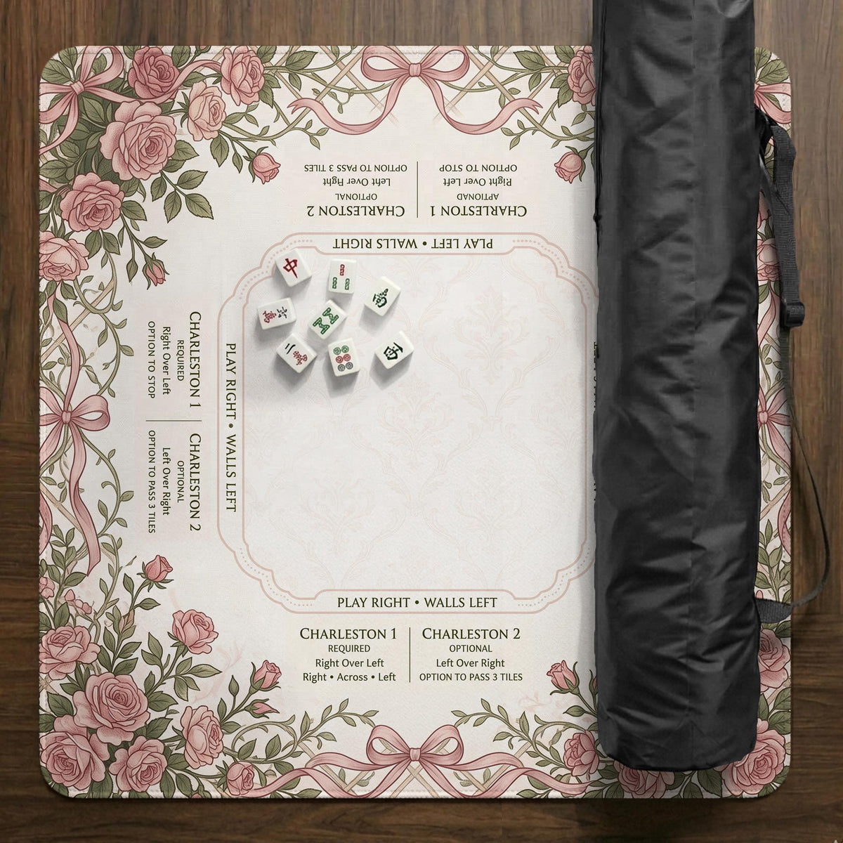 American mahjong mat with an ivory center, printed play-direction reminders, and a border of dusty-pink roses, ribbon bows, and green leaves.