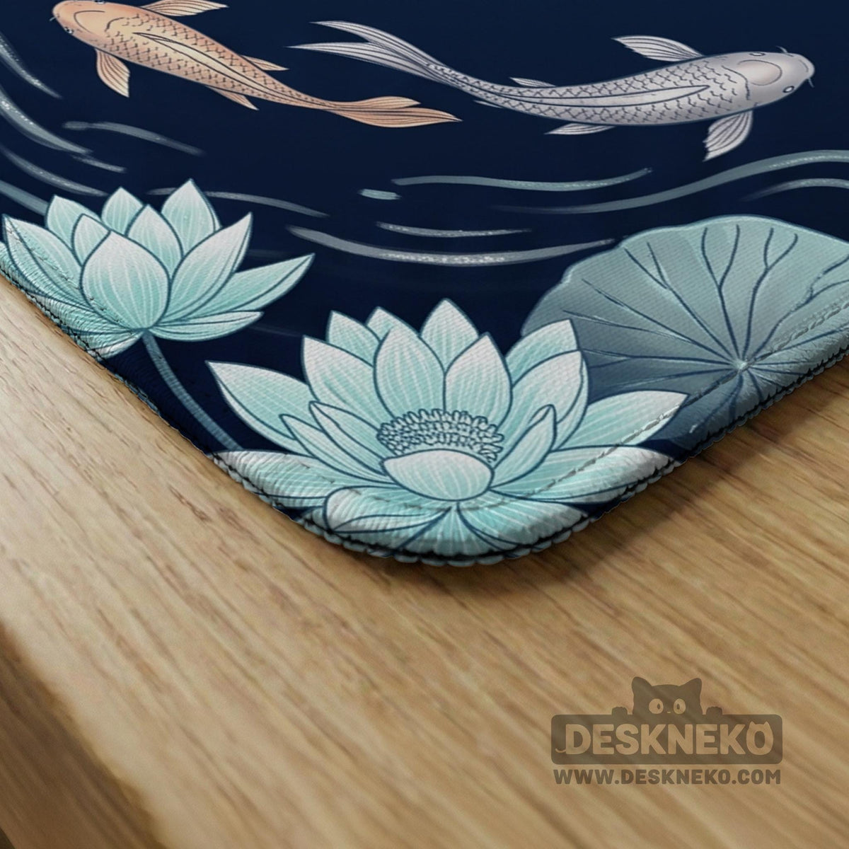 American mahjong mat with a navy-blue pond design, pale aqua lotus flowers, flowing water lines, koi fish, and printed play-direction and Charleston passing reminders.