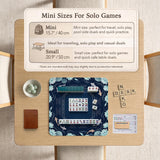 American mahjong mat with a navy-blue pond design, pale aqua lotus flowers, flowing water lines, koi fish, and printed play-direction and Charleston passing reminders.