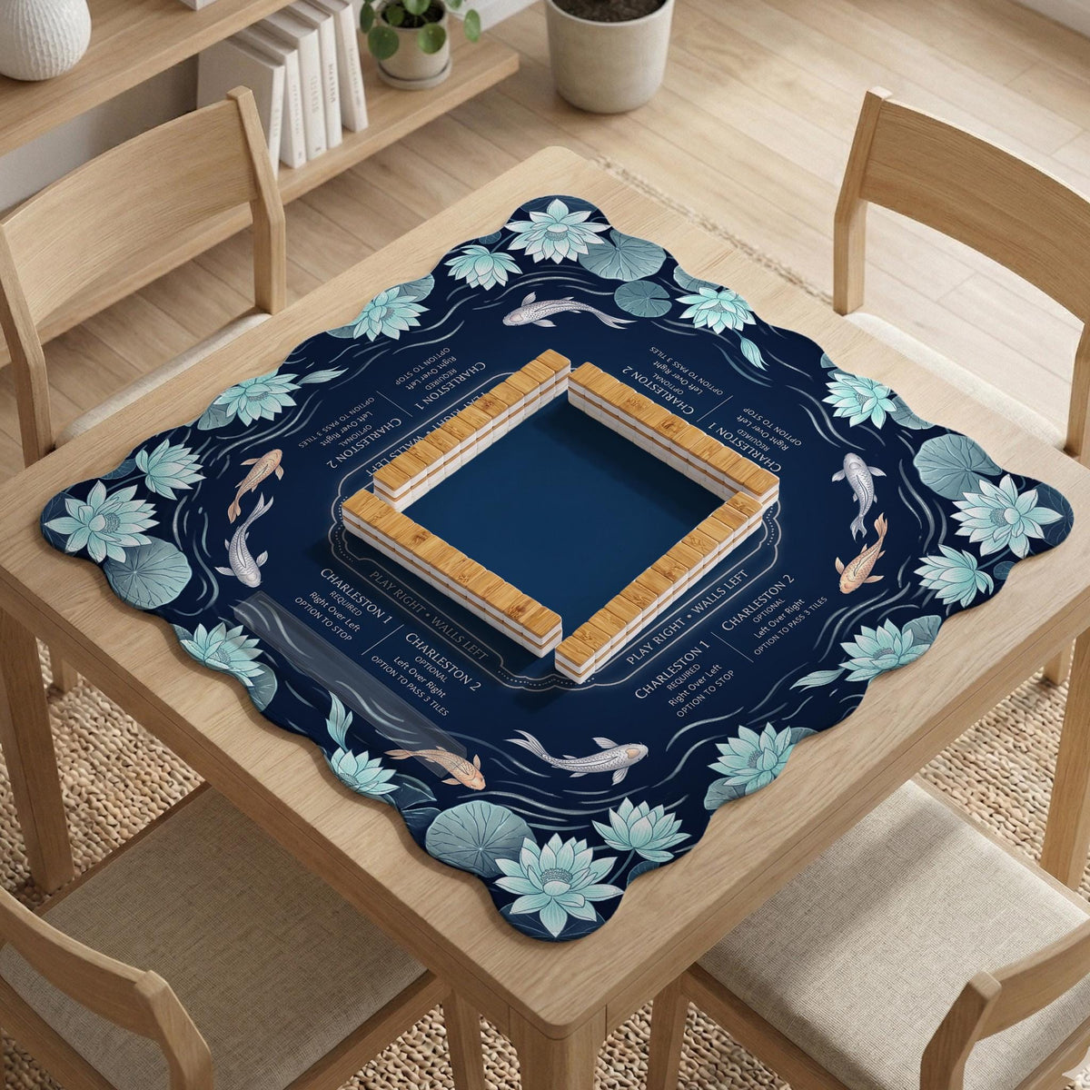 American mahjong mat with a navy-blue pond design, pale aqua lotus flowers, flowing water lines, koi fish, and printed play-direction and Charleston passing reminders.