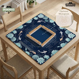 American mahjong mat with a navy-blue pond design, pale aqua lotus flowers, flowing water lines, koi fish, and printed play-direction and Charleston passing reminders.