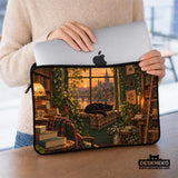 Illustration of a black cat beside stacked books and leafy plants in forest green, brown, and amber tones on a laptop sleeve and shoulder bag design.