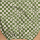 An office chair cover with a matcha green and ivory checker pattern and small four-petal flowers.
