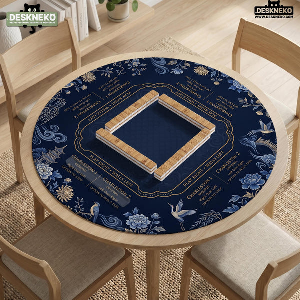 Navy mahjong mat with cranes, garden birds, pagodas, and blue and cream floral designs around a framed playing area with a printed Charleston guide.