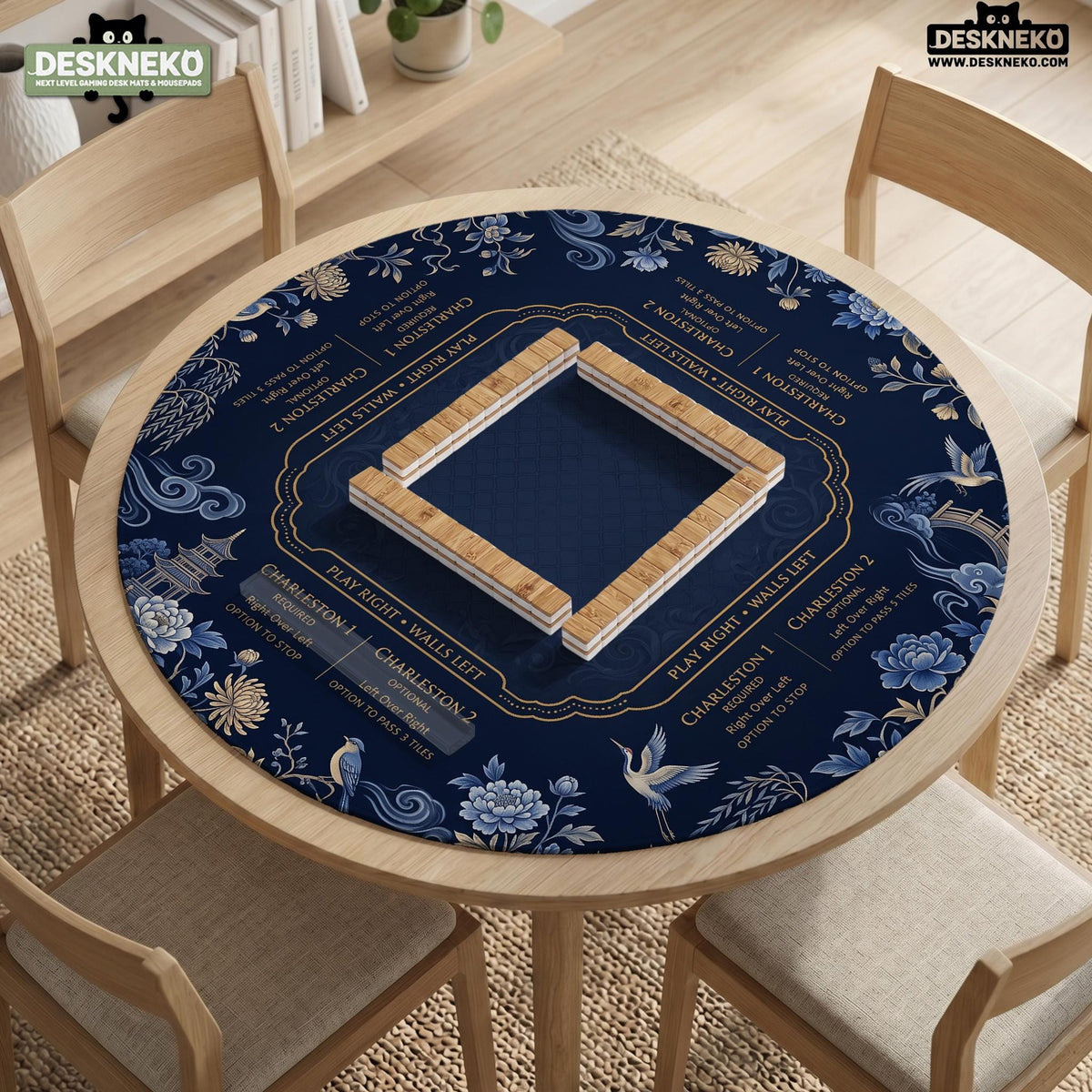Navy mahjong mat with cranes, garden birds, pagodas, and blue and cream floral designs around a framed playing area with a printed Charleston guide.