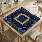 Navy mahjong mat with cranes, garden birds, pagodas, and blue and cream floral designs around a framed playing area with a printed Charleston guide.