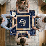 Navy mahjong mat with cranes, garden birds, pagodas, and blue and cream floral designs around a framed playing area with a printed Charleston guide.