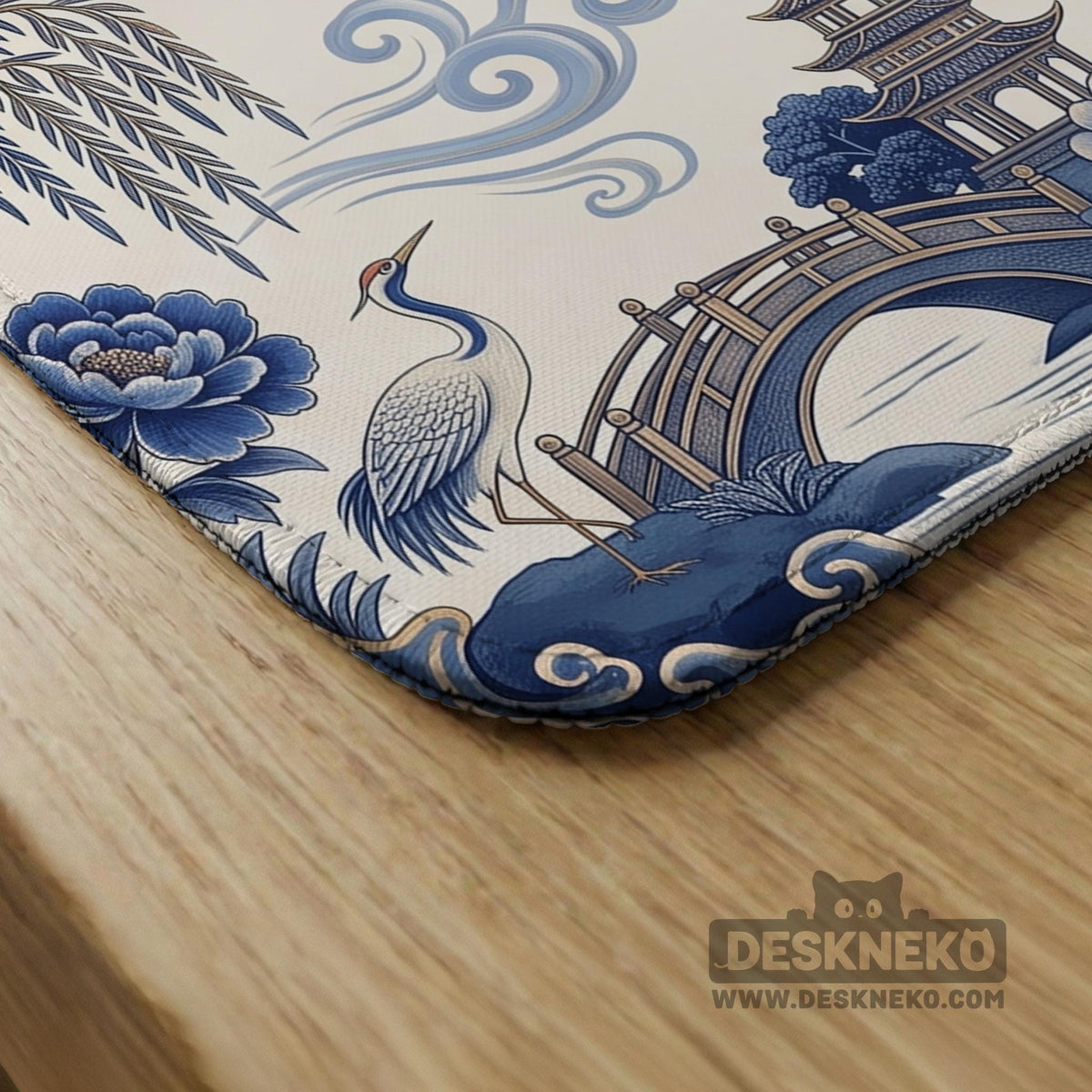 Square ivory mahjong mat with blue cranes, pagodas, flowers, and a blue border around the playing area.
