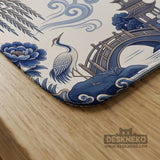 Square ivory mahjong mat with blue cranes, pagodas, flowers, and a blue border around the playing area.