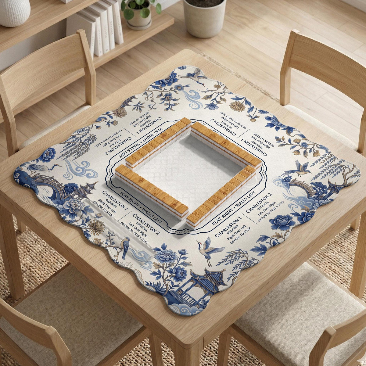 Square ivory mahjong mat with blue cranes, pagodas, flowers, and a blue border around the playing area.