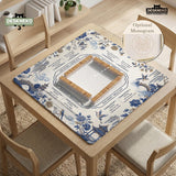 Square ivory mahjong mat with blue cranes, pagodas, flowers, and a blue border around the playing area.