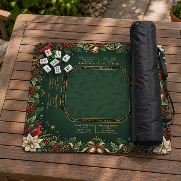 Green mahjong mat with red cardinals, holly berries, cream poinsettias, and gold seasonal details around a printed Charleston guide.