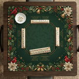 Green mahjong mat with red cardinals, holly berries, cream poinsettias, and gold seasonal details around a printed Charleston guide.