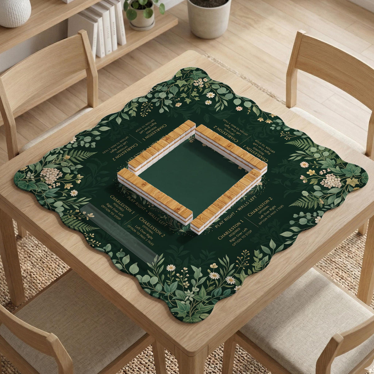 Square mahjong mat with a forest green botanical design, fern leaves, small cream flowers, and a printed Charleston guide around the center area.