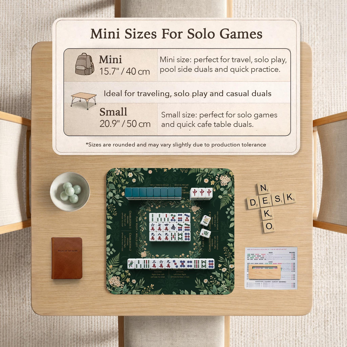 Square mahjong mat with a forest green botanical design, fern leaves, small cream flowers, and a printed Charleston guide around the center area.