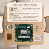 Square mahjong mat with a forest green botanical design, fern leaves, small cream flowers, and a printed Charleston guide around the center area.