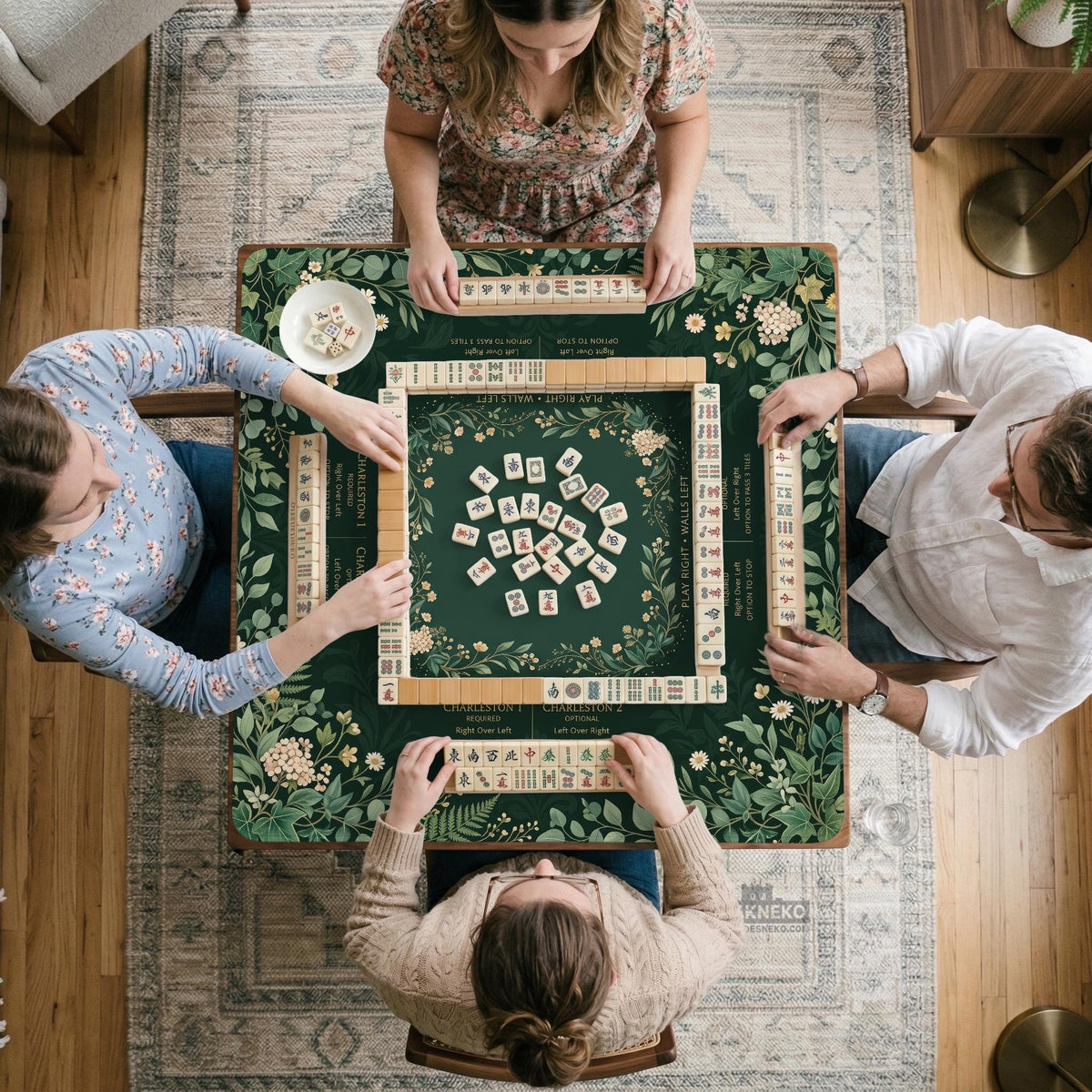 Square mahjong mat with a forest green botanical design, fern leaves, small cream flowers, and a printed Charleston guide around the center area.