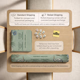 American mahjong mat with a sage-green pond scene, blue-grey herons, water lilies, reeds, and printed play-direction reminders around the edge.