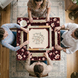Cream American mahjong mat with a burgundy border of pale pink magnolia blossoms and printed play-direction and passing reminders.