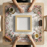 American mahjong mat with an ivory center, printed play-direction reminders, and a border of dusty-pink roses, ribbon bows, and green leaves.