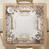 American mahjong mat with an ivory center, printed play-direction reminders, and a border of dusty-pink roses, ribbon bows, and green leaves.