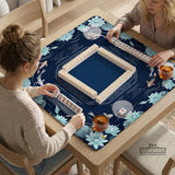 American mahjong mat with a navy-blue pond design, pale aqua lotus flowers, flowing water lines, koi fish, and printed play-direction and Charleston passing reminders.