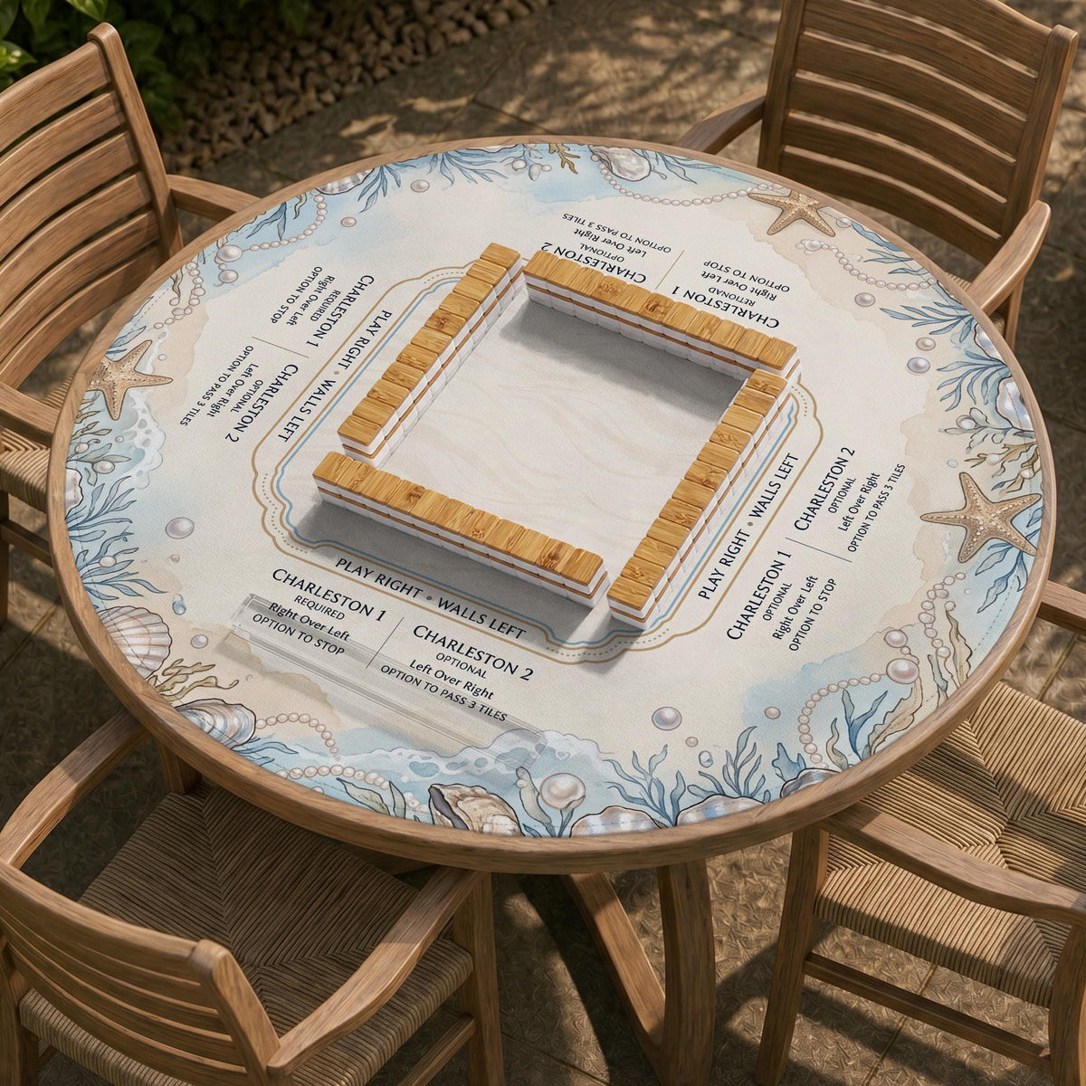 American mahjong mat with a cream center and a coastal border showing oyster shells, scallop shells, starfish, pearl strands, and pale blue sea plants.