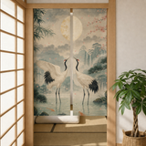 Two-panel Jade Crane Moon noren curtain shown in a doorway with botanical room styling.