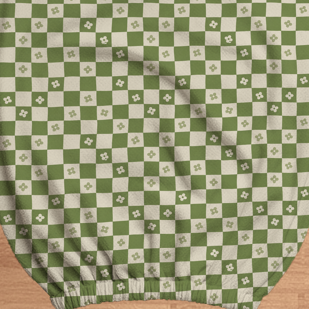 Matcha Checker Bloom printed stretch fabric and gathered elastic edge, shown in a construction closeup.